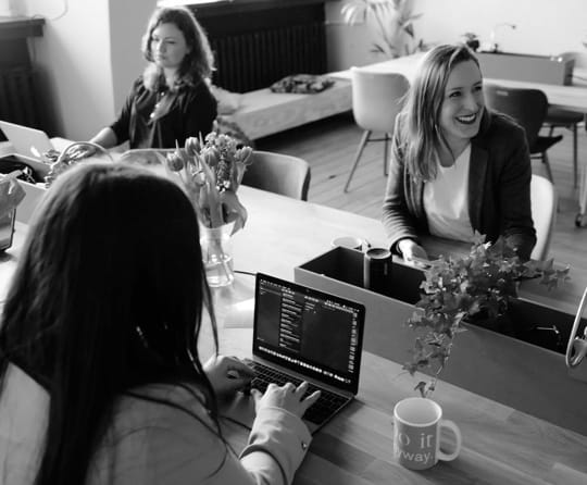 Two girl sitting in front of a computer